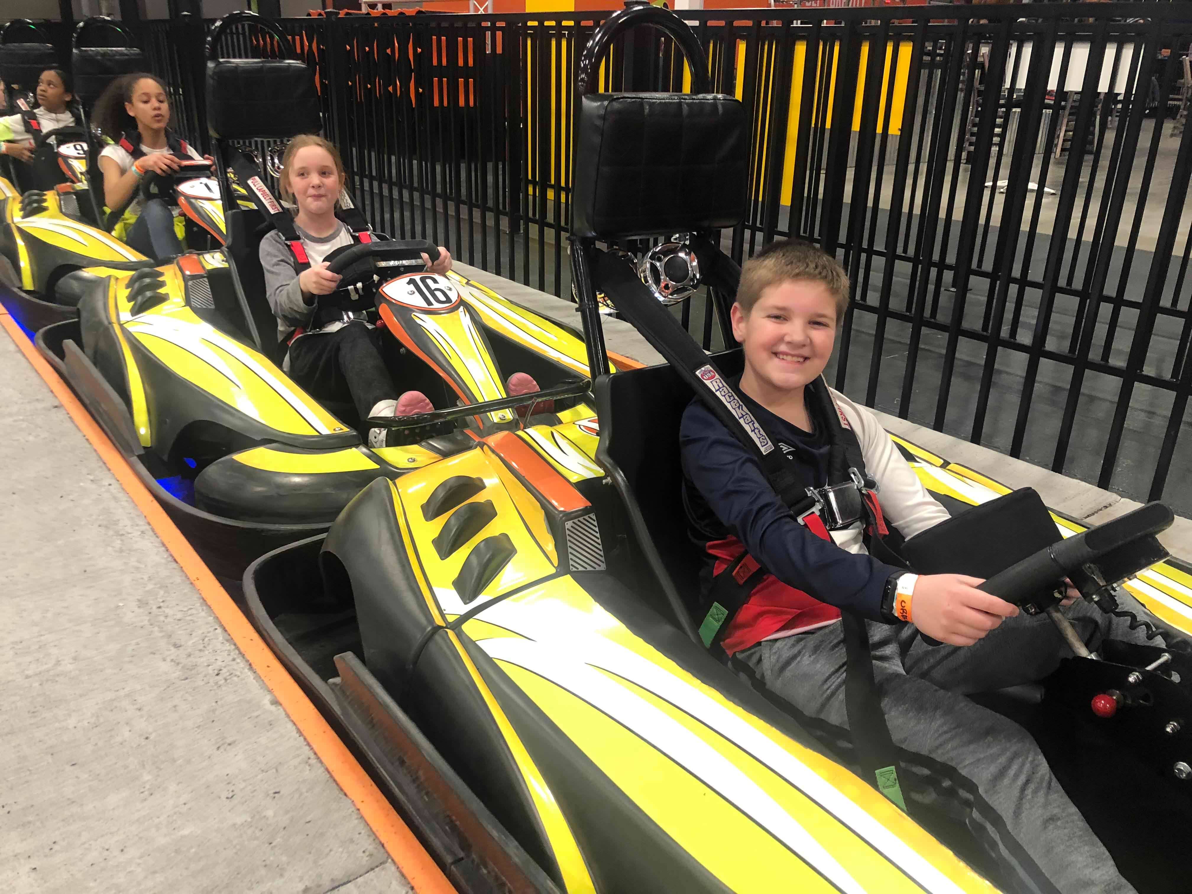 Kids in yellow go karts.