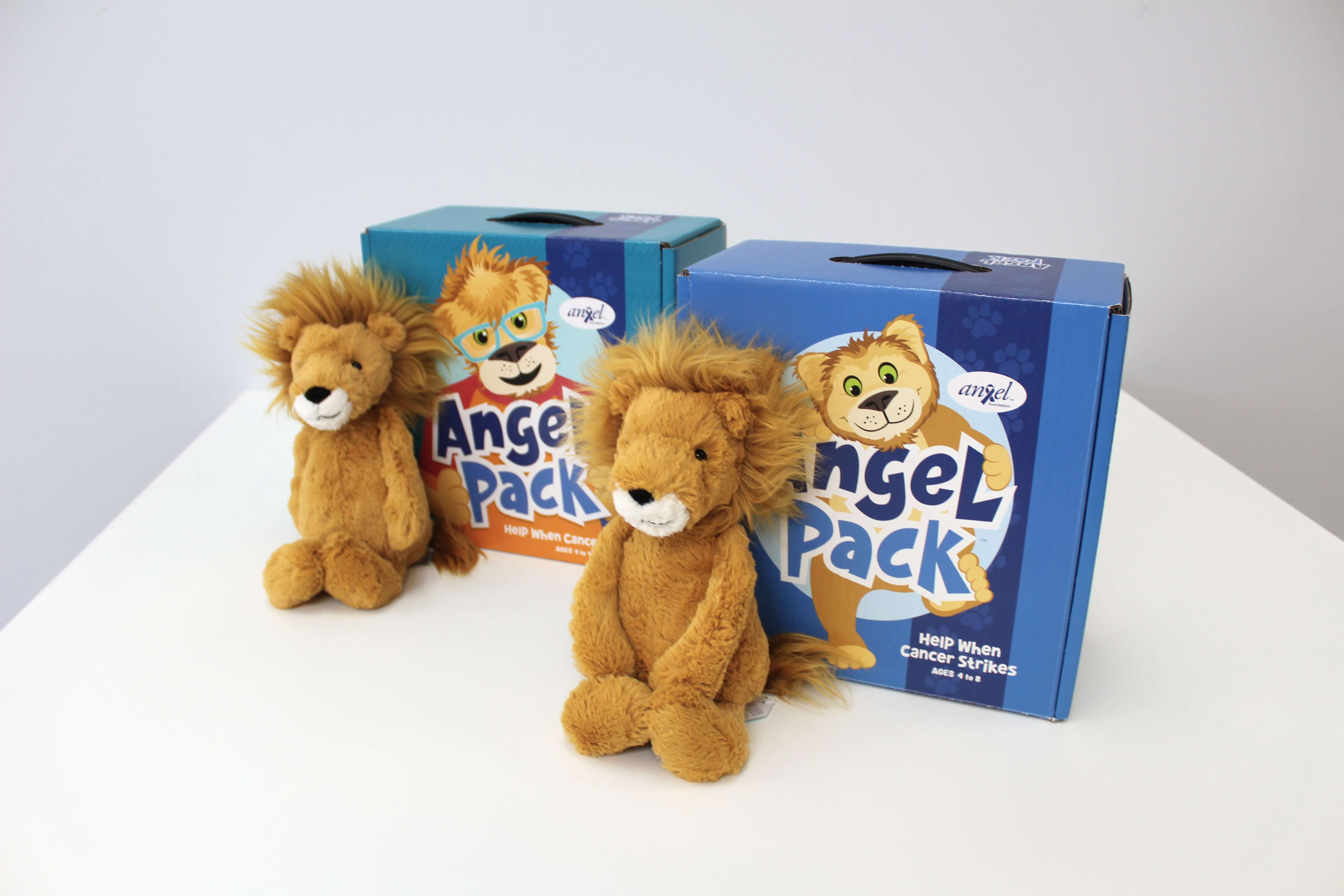 A side-by-side shot of the Child and Preteen Angel Packs with a stuffed lion leaning on each.