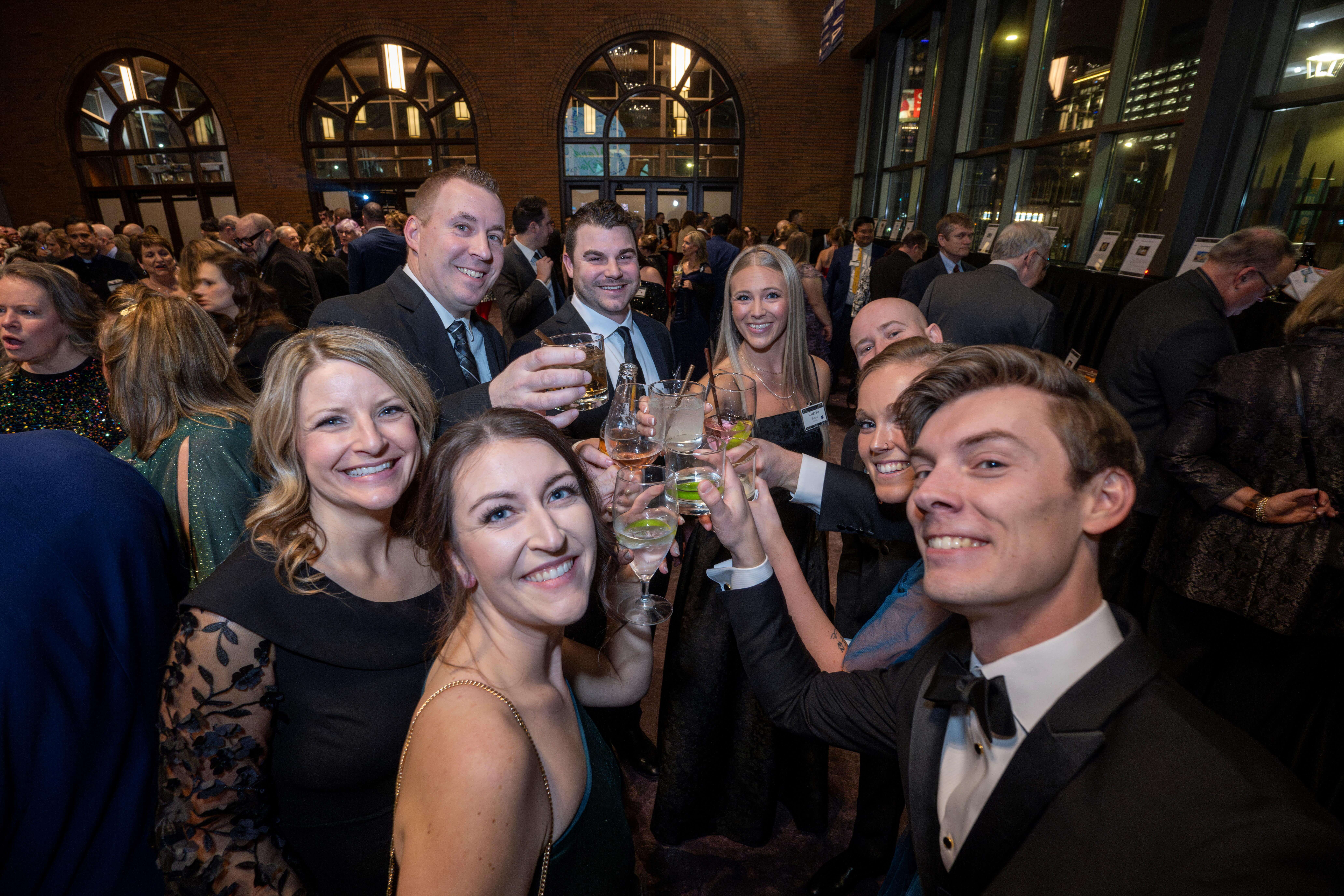 Angel Gala attendees cheers-ing to an incredible event.