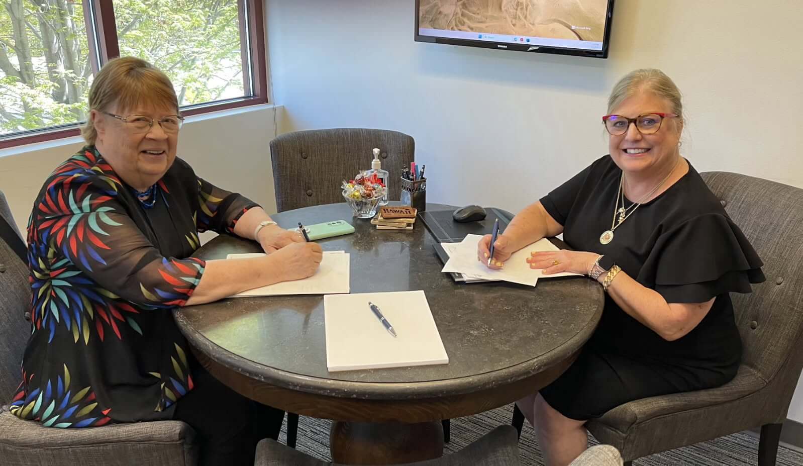 A Certified Financial Planner® meets with a client.