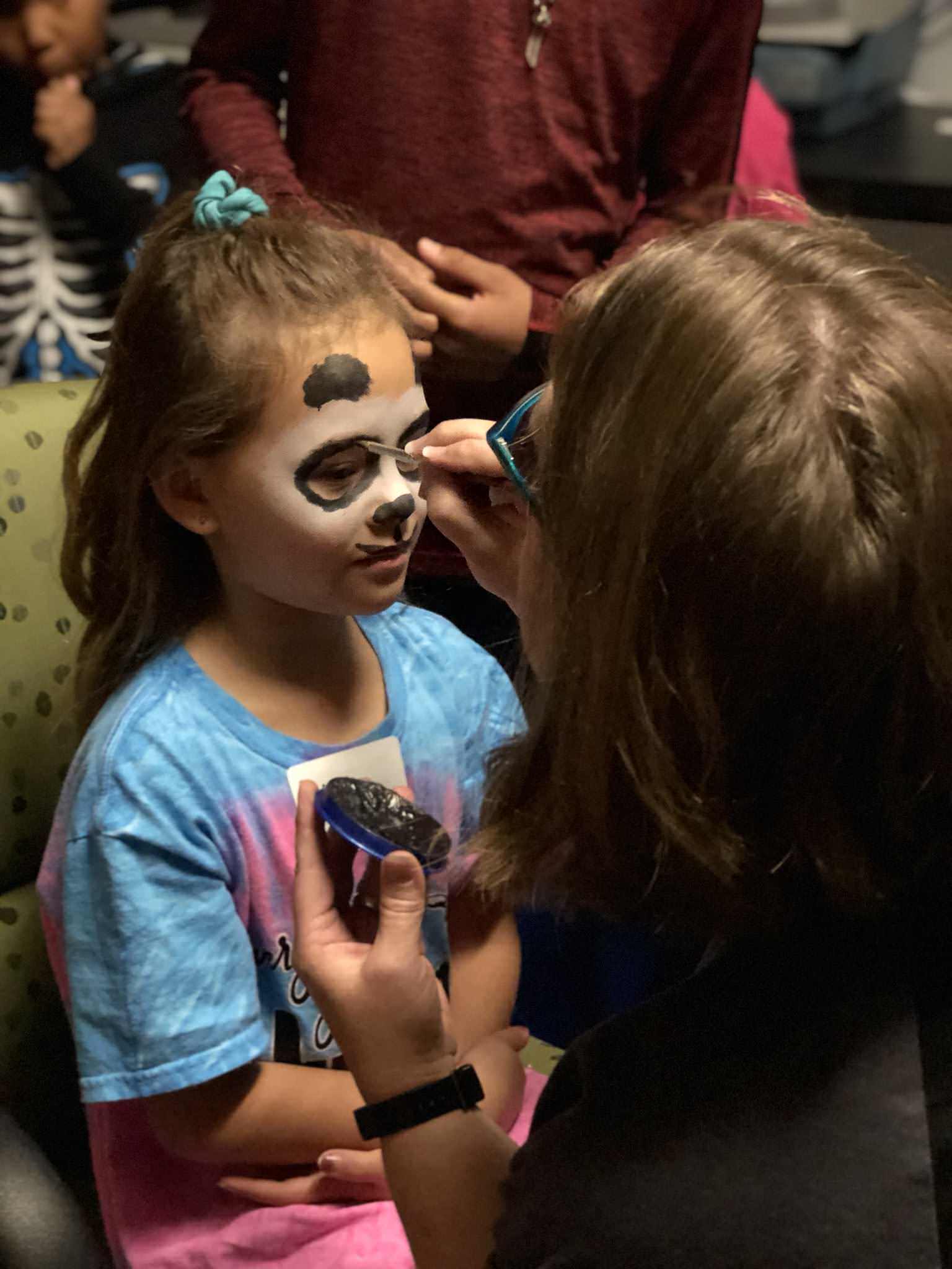 A girl getting her face painted