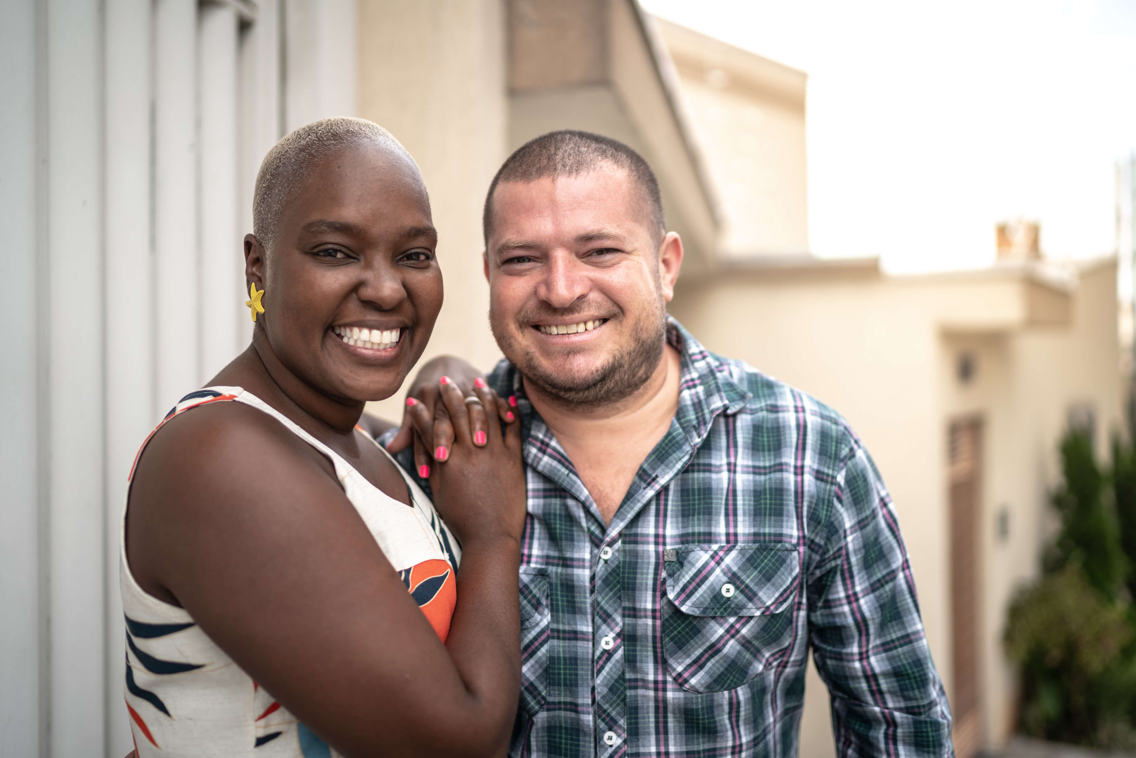 A black woman and a white man hugging and smiling