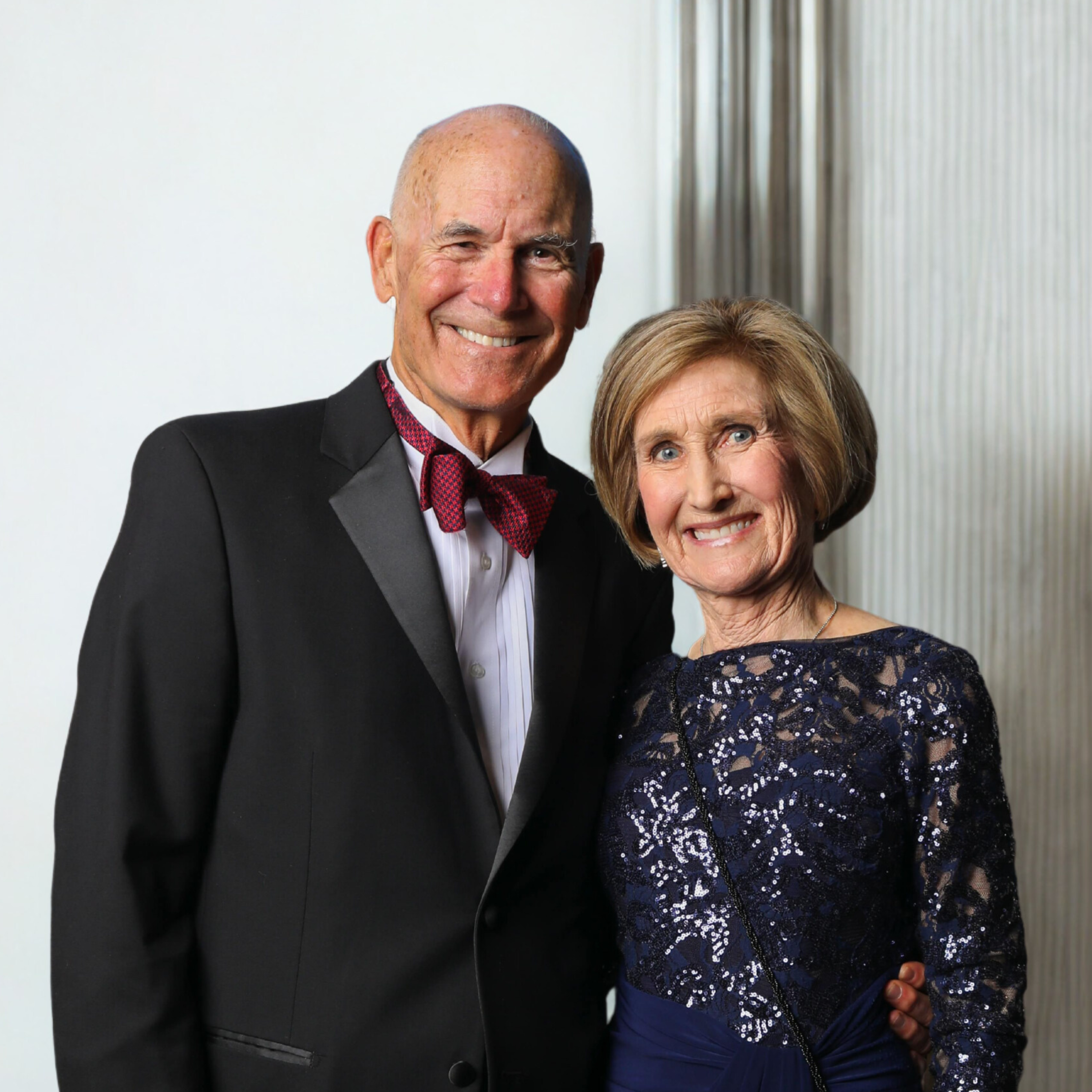 Angel Foundation’s™ founders, Mark and Margie, pose in front of Angel wings at an annual fundraiser.