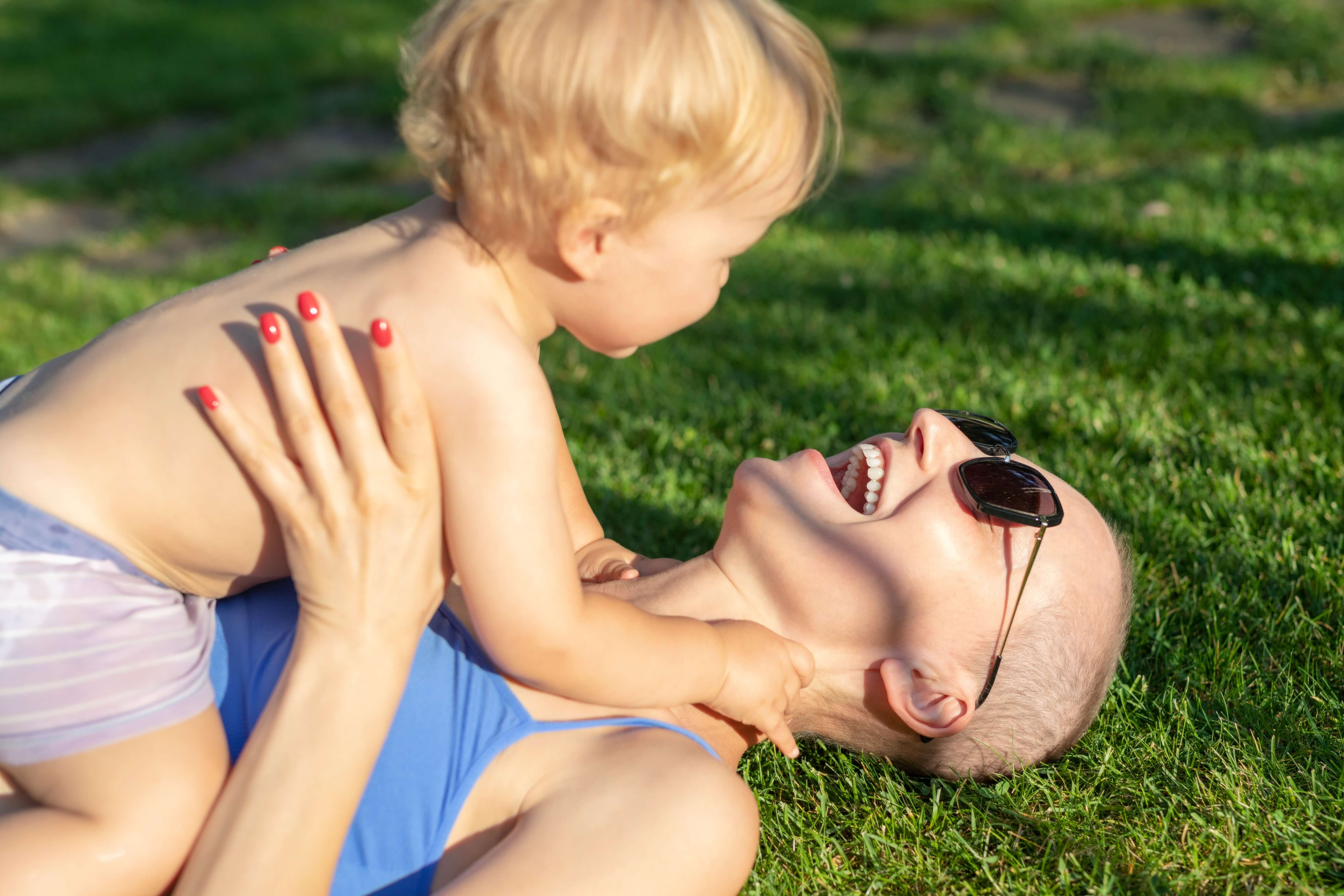 A mom with cancer and her son play outside.