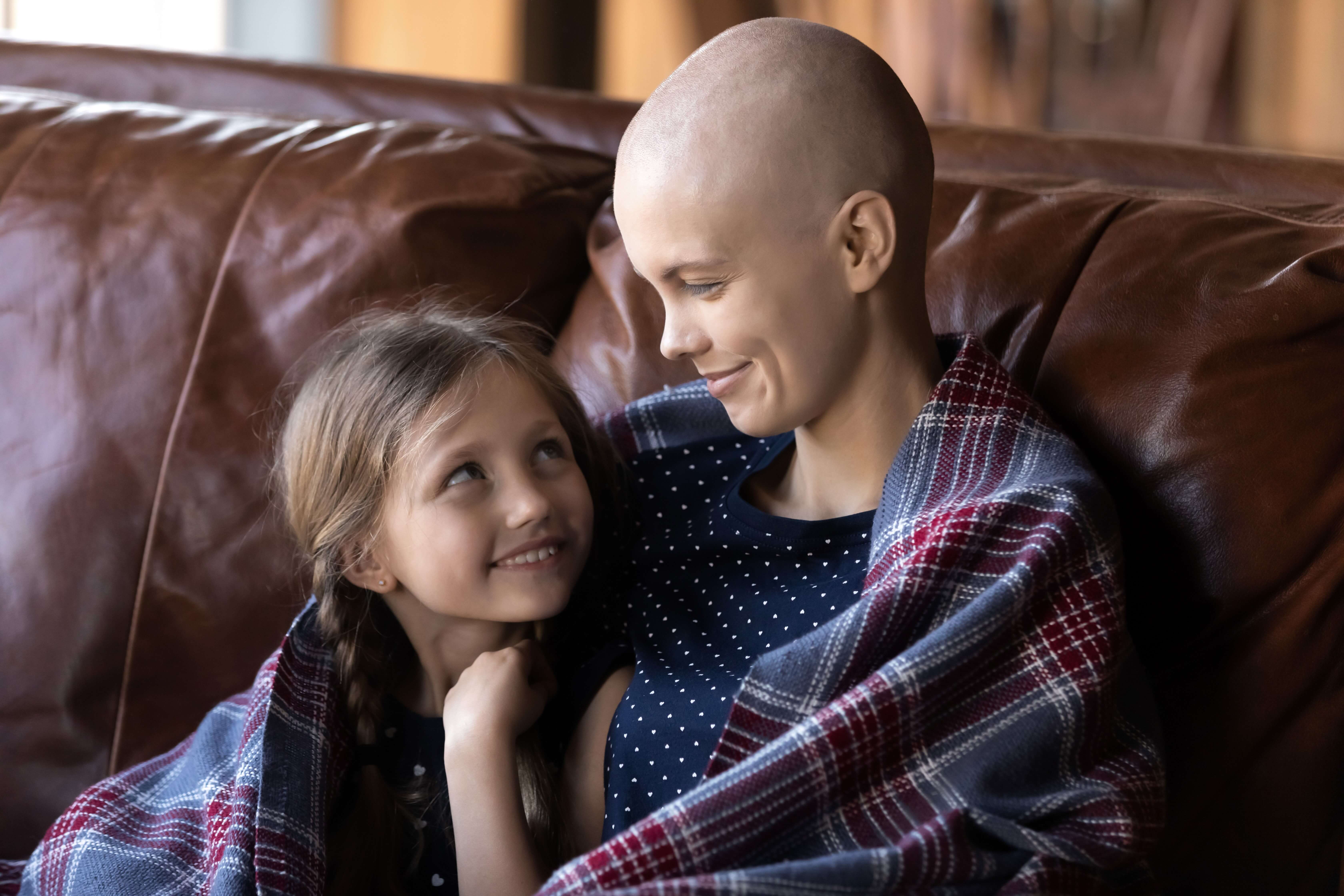 A mom and a daughter share a sweet glance.